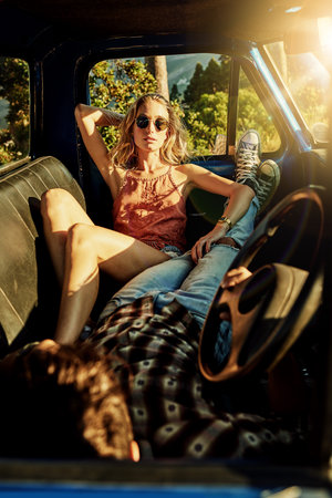 I live for adventures. a young couple out on a road trip with their truck.