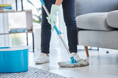 Mop, flooring and woman cleaning living room house, home and apartment. Cleaner, maid and...