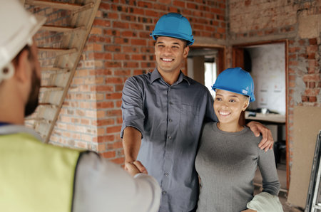 Handshake, construction and couple with home contractor make client agreement for house development,...