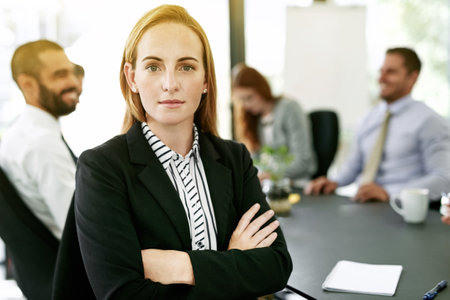 Heading up the meeting with serious confidence. Portrait of a businesswoman having a formal meeting in a boardroom.の写真素材