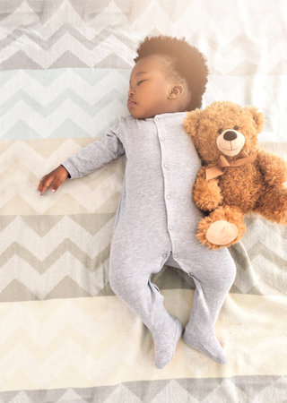 Sweet dreams are made of these. a little baby boy sleeping on a bed.