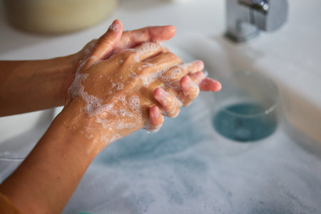 Hand wash, cleaning and sink washing for healthcare, wellness and virus safety in a bathroom. Skin...