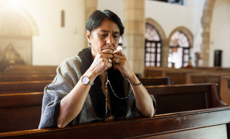 Faith, senior woman and in church with rosary for prayer, worship God and religion. Religious,...