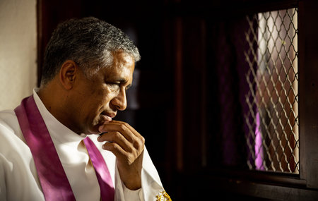 Confession, church and priest in a booth listening to confessing of sin, mistakes or problems....
