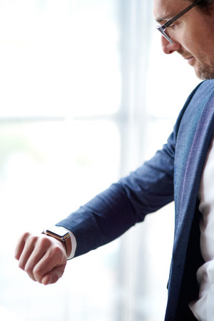 Someone on a mission has no time for competition. a businessman looking at the time.の写真素材