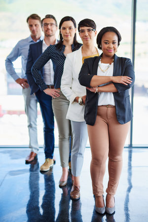 In line for corporate success. Portrait of a team of diverse colleagues standing together in a line...