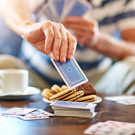 Seniors playing cards in their retirement home.