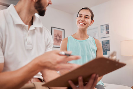 Physical therapy, exam and healthcare man with woman in massage office, clinic or wellness room for contract, advice and medical paperwork. Physiotherapy expert checklist document consulting patientの写真素材