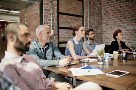 Paying close attention. a group of businesspeople meeting in the boardroom.の写真素材