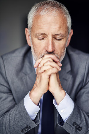 Hes got a lot on his mind. a mature businessman looking pensive in his office.の写真素材