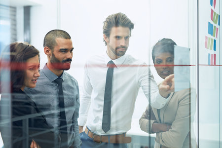 Taking their team to the top. colleagues brainstorming in the office.