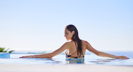 Bikini season is back. a young woman in a swimming pool.の写真素材