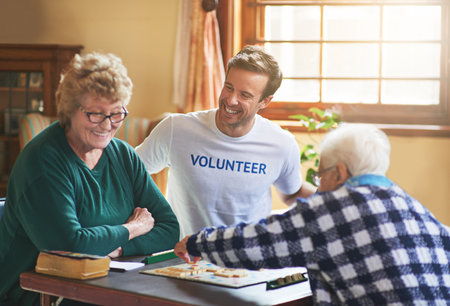 It feels good to do good. a volunteer working with seniors at a retirement home.の写真素材