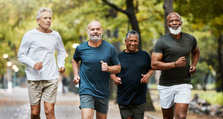 Fitness, running and group of senior men doing exercise, training and workout together in park on weekend. Nature, friendship and old males doing sports outdoors for health, wellness and body careの写真素材