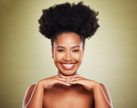Black woman, hands and smile for skincare beauty, cosmetics or makeup against a studio background. Portrait of African American female model smiling in satisfaction for perfect facial skin treatmentの写真素材