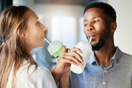 Restaurant, date and couple drinking a milkshake together while at a romantic summer adventure....