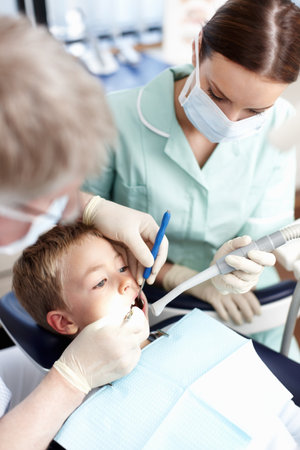 Young dental patient. Portrait of young dental patient taking treatment at dentist clinic.の写真素材