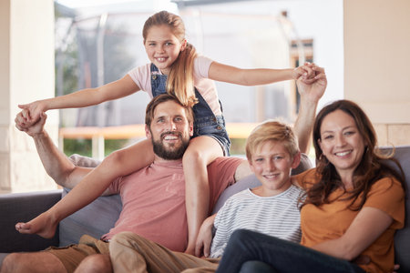 Family, love and relax on a sofa by children with parents in living room, happy and smile while bonding in their home. Portrait, happy family and kids with mom and dad in lounge, cheerful and playfulの写真素材
