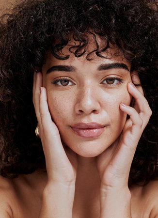 Beauty, portrait and natural face of black woman with healthy freckle skin texture touch. Aesthetic, facial and skincare cosmetic model girl touching cheeks for self love and wellness.の写真素材