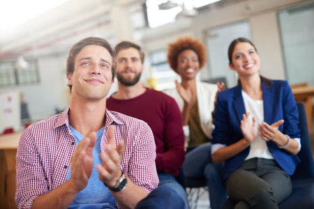 They like what theyre hearing. A group of colleagues applauding a work presentation.の写真素材