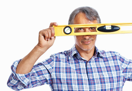 Handsome mature architect looking through spirit-level. Portrait of mature architect looking through...