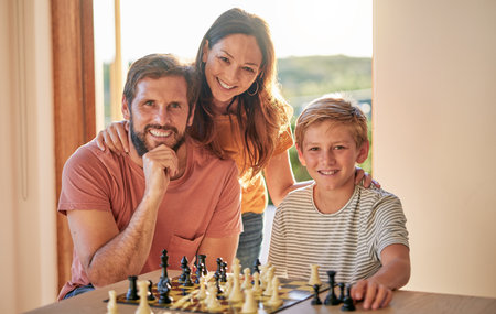 Family, chess and home youth brain development of a mother, father and child with a game. Happy kid and parents portrait with love and care ready for problem solving and knowledge board gameの写真素材