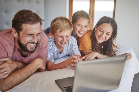 Laptop, family and children with a mother, father and kids bonding while watching a movie in a home...