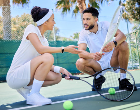 Tennis, planning and couple talking about training, motivation and workout for health on an outdoor court. Fitness, exercise and man and woman talking about a strategy for a game of sports togetherの写真素材
