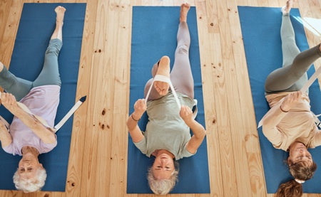 Gym, fitness, and elderly women group in yoga class from above, stretch and wellness exercise for...
