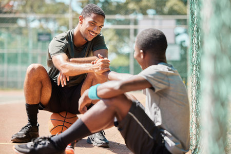 Teamwork, sports and friends with black man on basketball court holding hands for support, congratulations and training. Fitness, help and community with basketball player for game, respect or faithの写真素材