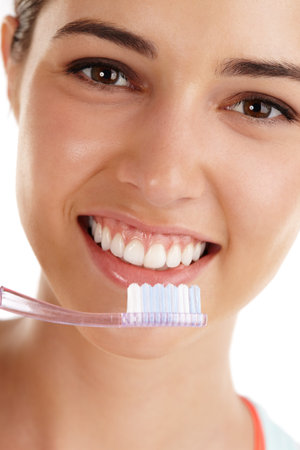 The secret to my perfect smile. Beautiful young lady holding toothbrush and smiling.