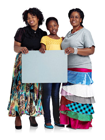 A message for the ladies. Studio shot of two african women with a teenage girl holding a blank...