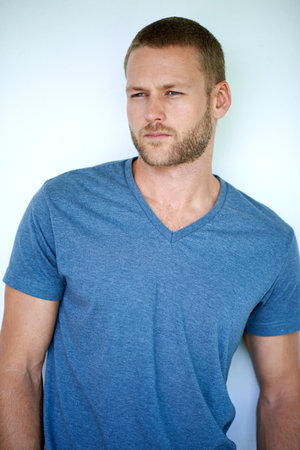 Hes all about the style. Studio shot of a handsome young man posing against a white background.の写真素材