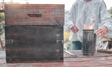 Beekeeper, fire and production of honey for food, sustainability and small business on a farm....