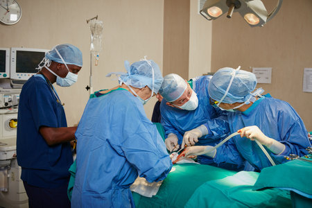 Saving lives is their calling. a team of surgeons performing a surgery in an operating room.の写真素材