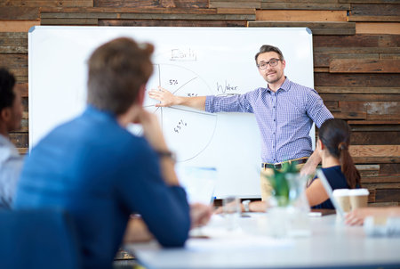 We never fail to plan. Mature professional using a white board to give a presentation in a bright...