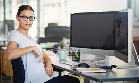 Focused on my career goals. Portrait of a designer sitting at her desk in an office.の写真素材