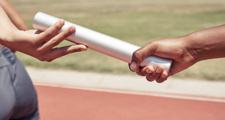 Hands, team and sports relay baton for running, sprint or fitness marathon for olympic athletics on stadium track. Hand of runner holding bar in teamwork sport for run, race or competition of speedの写真素材