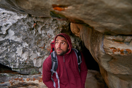 No stopping now...a young man enjoying a hike through the mountains.の写真素材