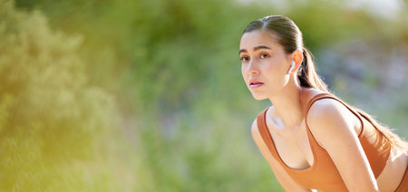 Fitness, woman and break in running exercise, workout or cardio training for healthy wellness on mockup. Active female breathing after intense run for energy recovery in nature for sports healthの写真素材