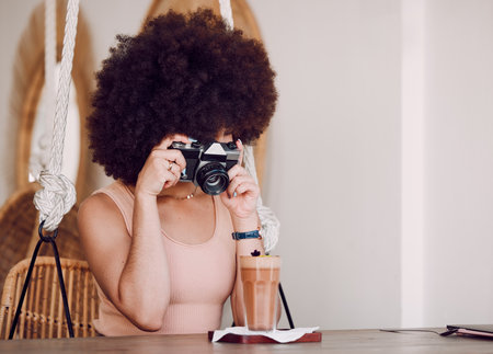 Black woman, camera and drink for social media, online post and blogger. African American female, young girl or influencer take picture, for posting on internet or milkshake for creative photographerの写真素材