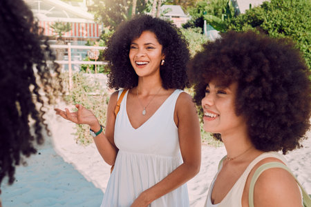 Smile, black women at beach with conversation outdoor, together on holiday. African American group, ladies or girls happy with confidence, talking or discussion for vacation, travel and happinessの写真素材
