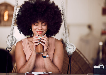 Black woman, coffee and relax at cafe with smell of drink or tea for self care, mental health or calm break. Happy african woman, latte or iced coffee with smile, peace or happiness in coffee shopの写真素材