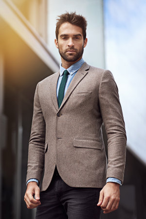 My style speaks of my success. a handsome and stylish young businessman in an urban setting.の写真素材