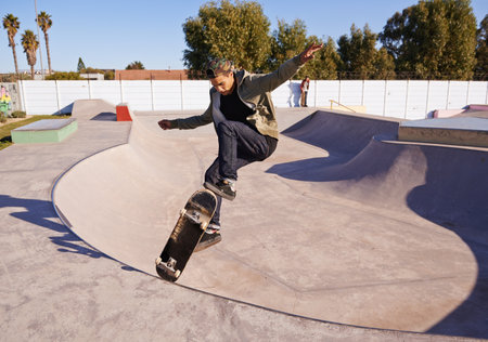 Check THIS out. A young man doing tricks on his skateboard at the skate park.の写真素材