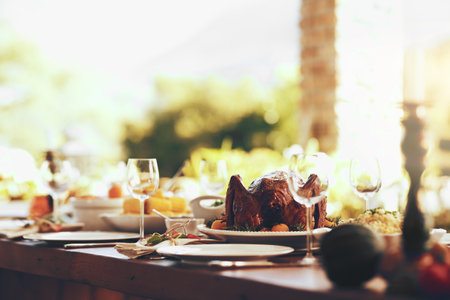 Food, table and traditional celebration on a patio with no people for thanksgiving, party and a fun gathering setup for family at home. Turkey, chicken and dining table ready for family lunch outdoorの写真素材