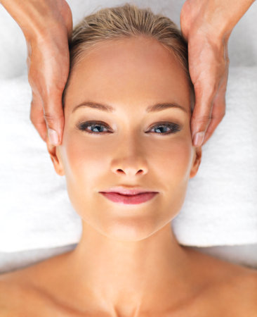 Nothing beats a spa day for total rejuvenation. A beautiful young woman relaxing in a spa.の写真素材