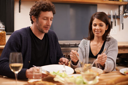 Which piece do you want. a happy couple sitting down to dinner.