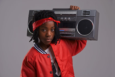 Turn down for what. Studio shot of a young boy dressed in hip hop attire.