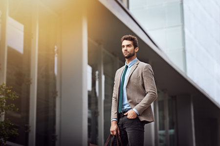 Metropolitan man. a handsome and stylish young businessman in an urban setting.の写真素材